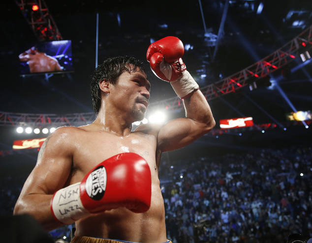 Manny Pacquiao of the Philippines celebrates after defeating Timothy Bradley in the WBO welterweight title boxing bout Saturday