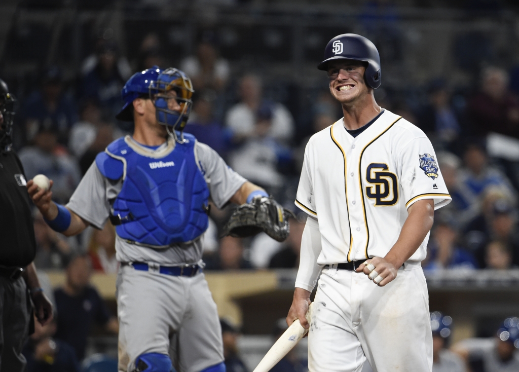 SAN DIEGO CALIFORNIA- APRIL 04 Wil Myers #4 of the San Diego Padres grimaces after taking a strike during the ninth inning of a baseball game against the Los Angeles Dodgers on opening day at PETCO Park