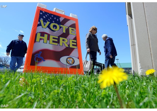 People enter and exit the Utica Armory to vote in the New York presidential primaries Tuesday 19 April 2016 in Utica NY.- AP