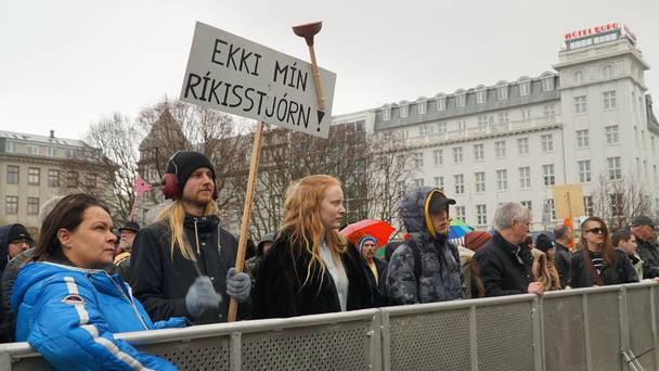 People protest in front of the parliament building in Reykjavik for a third consecutive day