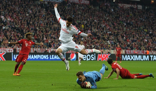 Benfica’s Raul Jimenez leaps over Bayern goalkeeper Manuel Neuer during the Champions League quarterfinal first leg soccer match between FC Bayern Munich and Benfica Lisbon at the Allianz Arena in Munich