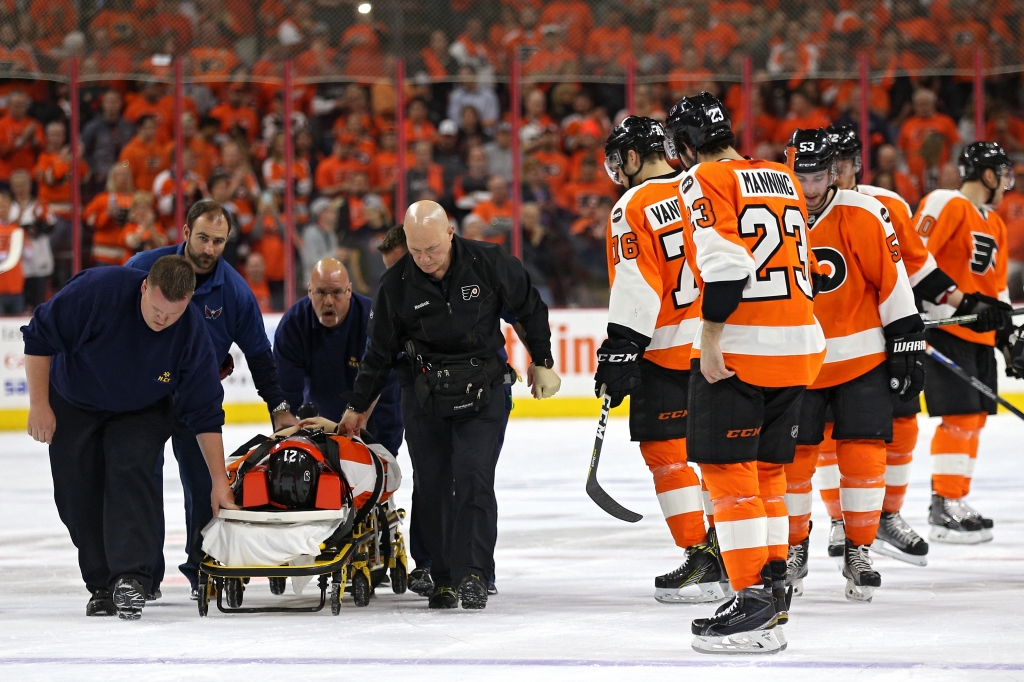 PHILADELPHIA PA- APRIL 20 Scott Laughton #21 of the Philadelphia Flyers is carted off of the ice after being injured against the Washington Capitals in the first period in Game Four of the Eastern Conference Quarterfinals during the 2015 NHL Stanley Cu