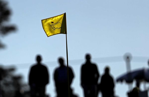 Spectators line the 18th green during a practice