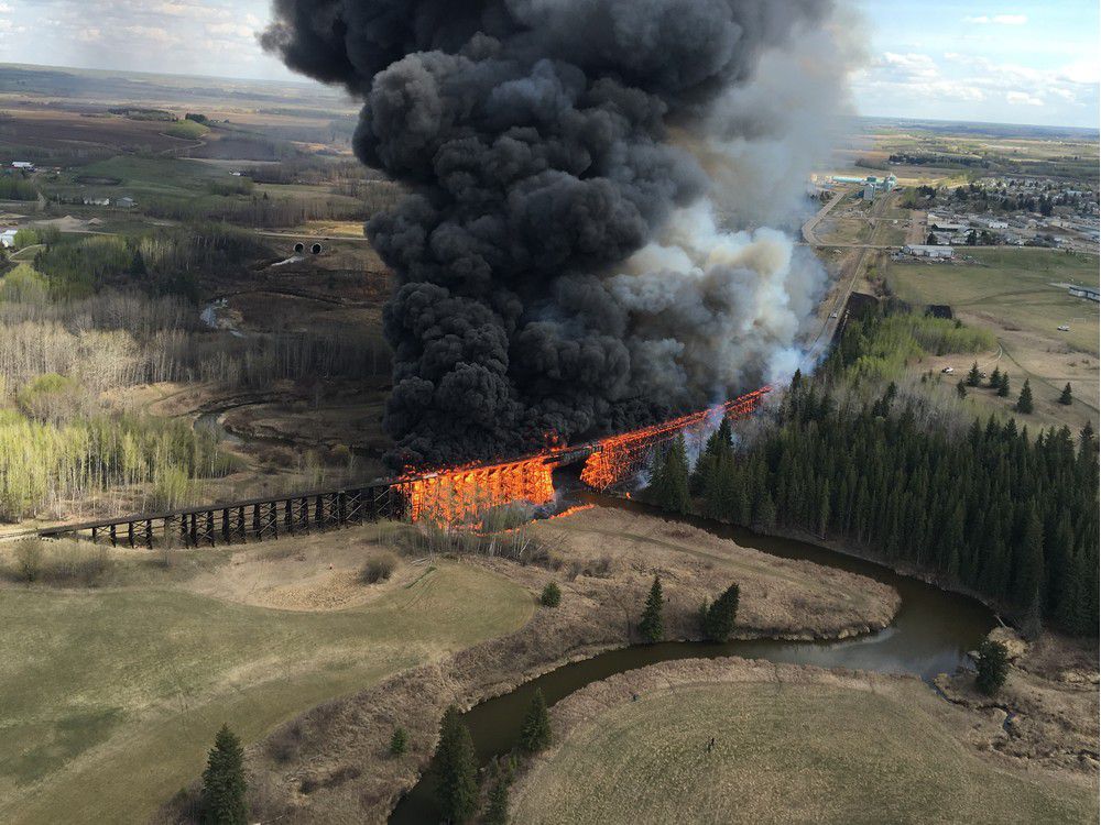 Flames engulf a wooden trestle bridge on the outskirts of Mayerthorpe Alta. on Tuesday April 26