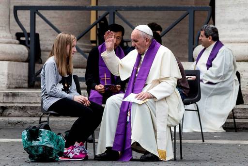 Pope Francis confesses a young faithful during the Youth Jubilee at Saint Peter square in Vatican