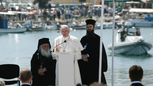 Pope Francis delivers an address at the port of Lesbos alongside leaders of the Greek Orthodox Church