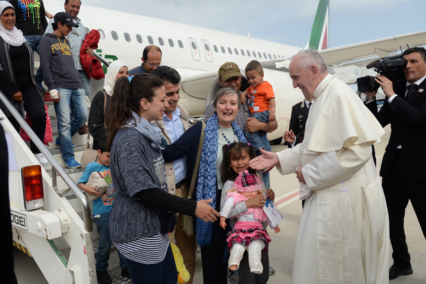 Pope Francis welcomes a group of Syrian refugees after landing in Rome following a visit at the Moria refugee camp