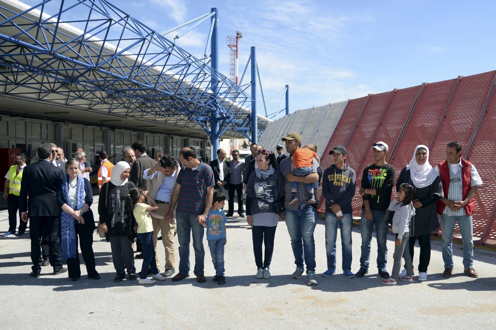 A group of Syrian refugees wait to board a plane with Pope Francis at the airport of Mytilene in the Greek island of Lesbos