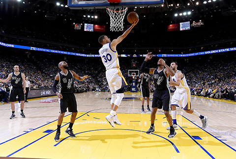 OAKLAND CALIFORNIA- APRIL 07 Stephen Curry #30 of the Golden State Warriors goes up to score on a reverse layup against the San Antonio Spurs in the third quarter of an NBA Basketball game at ORACLE Arena