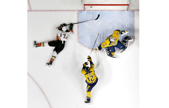 Anaheim Ducks’ center Ryan Kesler scores a goal against Nashville Predators’ goalie Pekka Rinne of Finland and forward Mike Fisher in the second period of Game 6 of their NHL first-round Stanley Cup playoff series in Nashvil