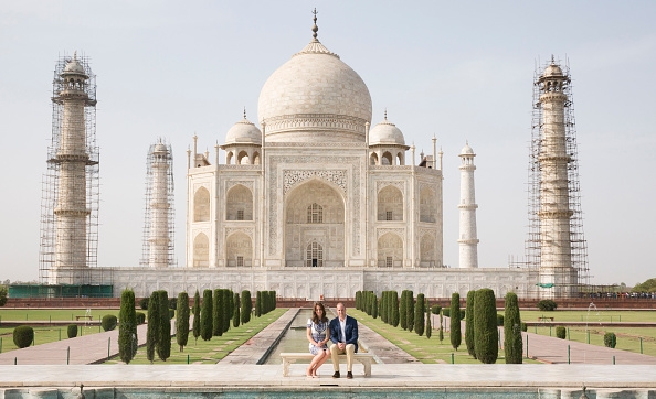 Prince William and Duchess of Cambridge Kate Middleton sit in front of the Taj Mahal