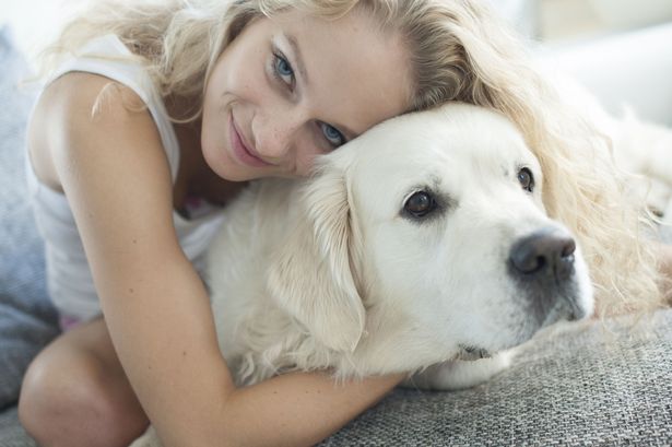 Woman hugging dog