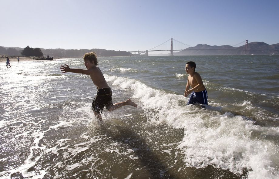 Trent Portman and Miles Yakura play in the surf during a hot day at Crissy Field Sept. 18 2009. The Bay Area was expected to see record temperatures Wednesday ahead of a dramatic cool down and chances of rain heading toward the weekend