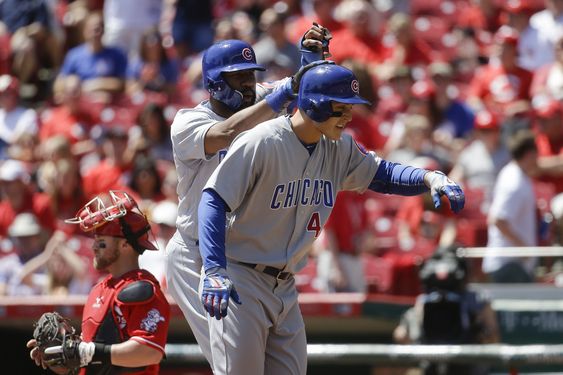 Rizzo celebrates with teammate Jason Heyward center left after hitting a two-run home run off Cincinnati Reds starting pitcher Alfredo Simon in the first inning of a baseball game Sunday