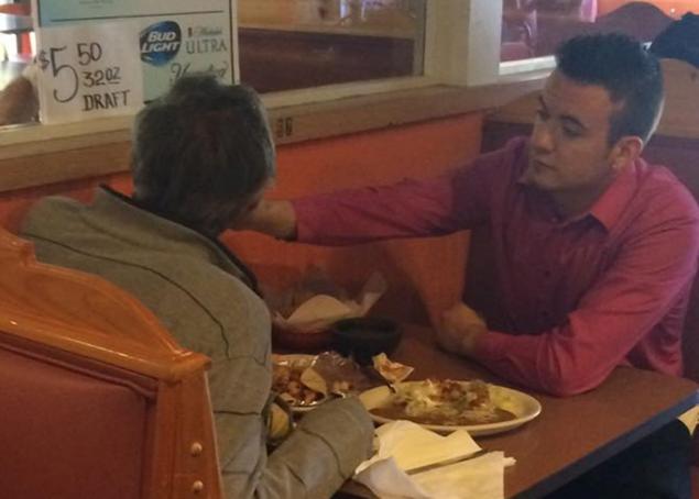 Alex Ruiz a 22-year-old server helps feed a man without hands at a Cinco de Mayo restaurant in Georgia