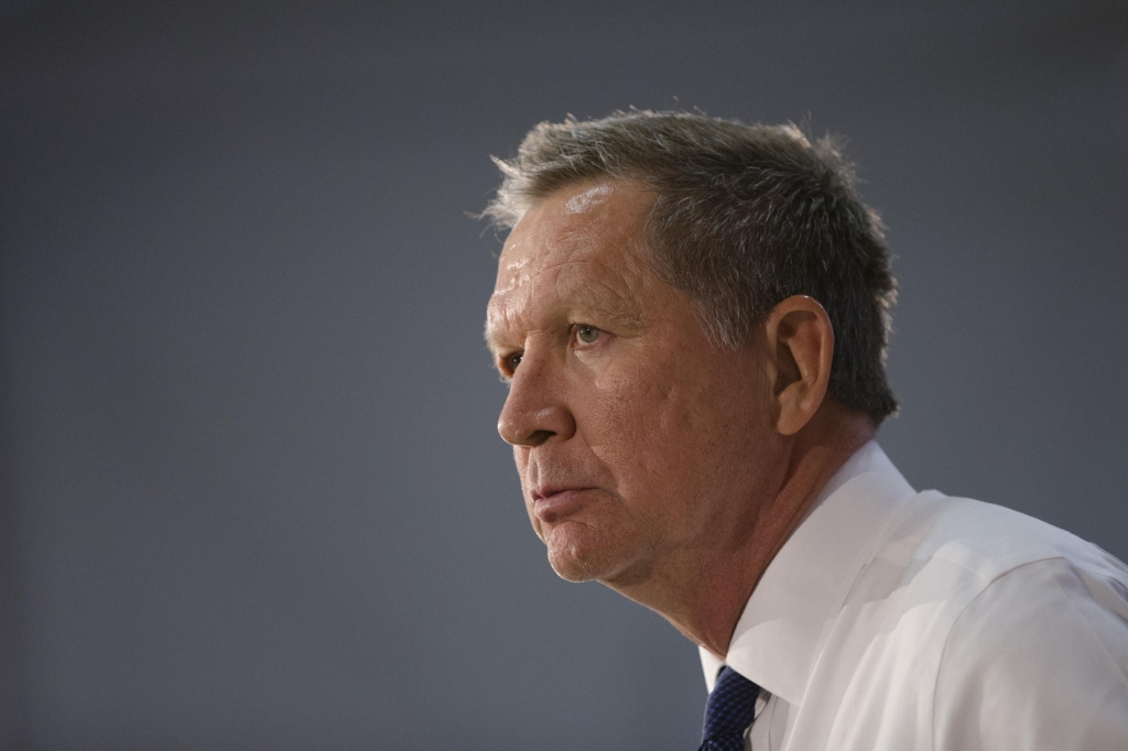 Republican presidential candidate Ohio Gov. John Kasich listens to an audience member's question during a campaign stop at Solvay Youth Center on Monday