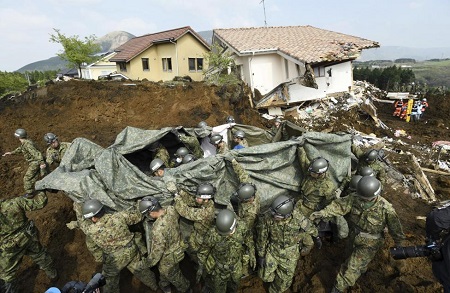 Japan Ground Self Defense Force soldiers carry the a person found under landslide rubble following an earthquake in Minamiaso town Kumamoto prefecture southern Japan