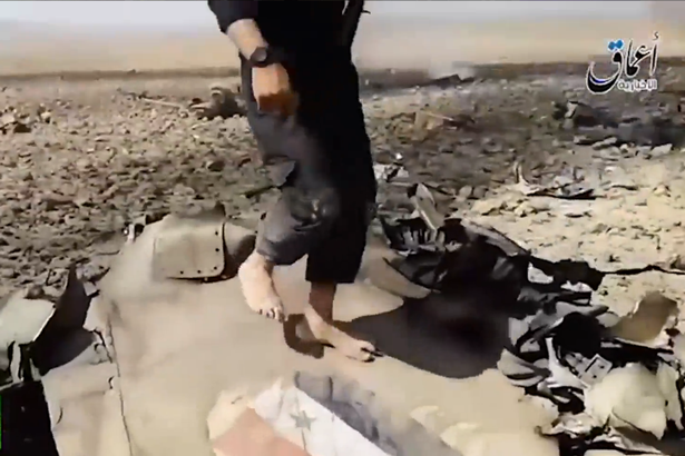 ISIS militants climb on burning jet wreckage