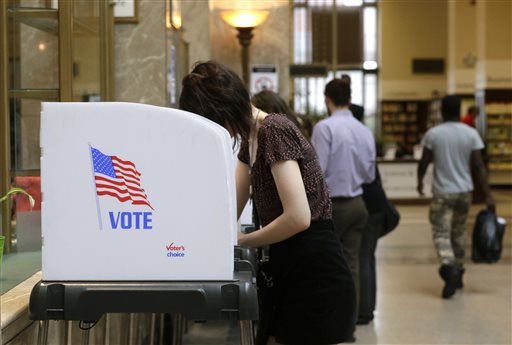 People cast their votes at a polling station inside the Enoch Pratt Free Library's central library branch in Baltimore Tuesday