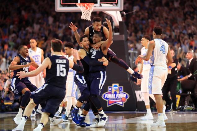 Villanova’s Kris Jenkins celebrates after making the game-winning three pointer to defeat North Carolina