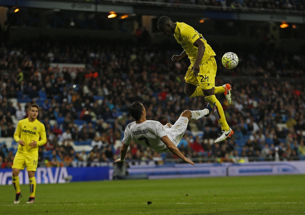 Real Madrid's Cristiano Ronaldo center attempts an over head kick next to Villarreal's Eric Bailly right during a Spanish La Liga soccer match between Real Madrid and Villarreal at the Santiago Bernabeu stadium in Madrid Wednesday April 20