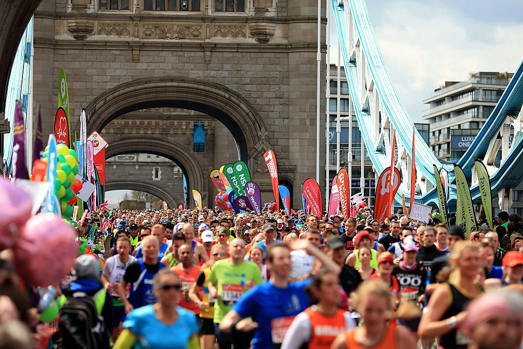 Runners make their way across Tower Bridge during the Virgin Money London Marathon on Saturday in London