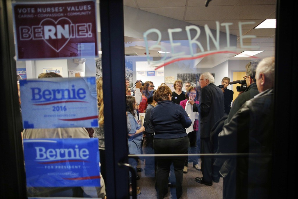 Democratic presidential candidate Bernie Sanders talks to supporters as they open a new regional campaign field office in Salem New Hampshire.. Sanders said he is planning to lay off hundreds of campaign workers nationwide and focus on winning in Califor