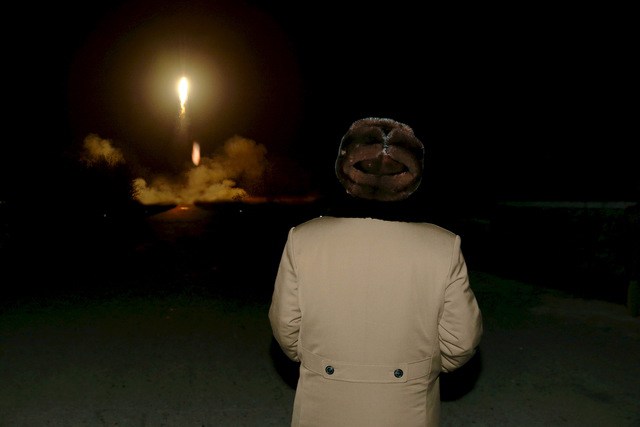 North Korean leader Kim Jong Un watches the ballistic rocket launch drill of the Strategic Force of the Korean People's Army at an unknown location in this undated file