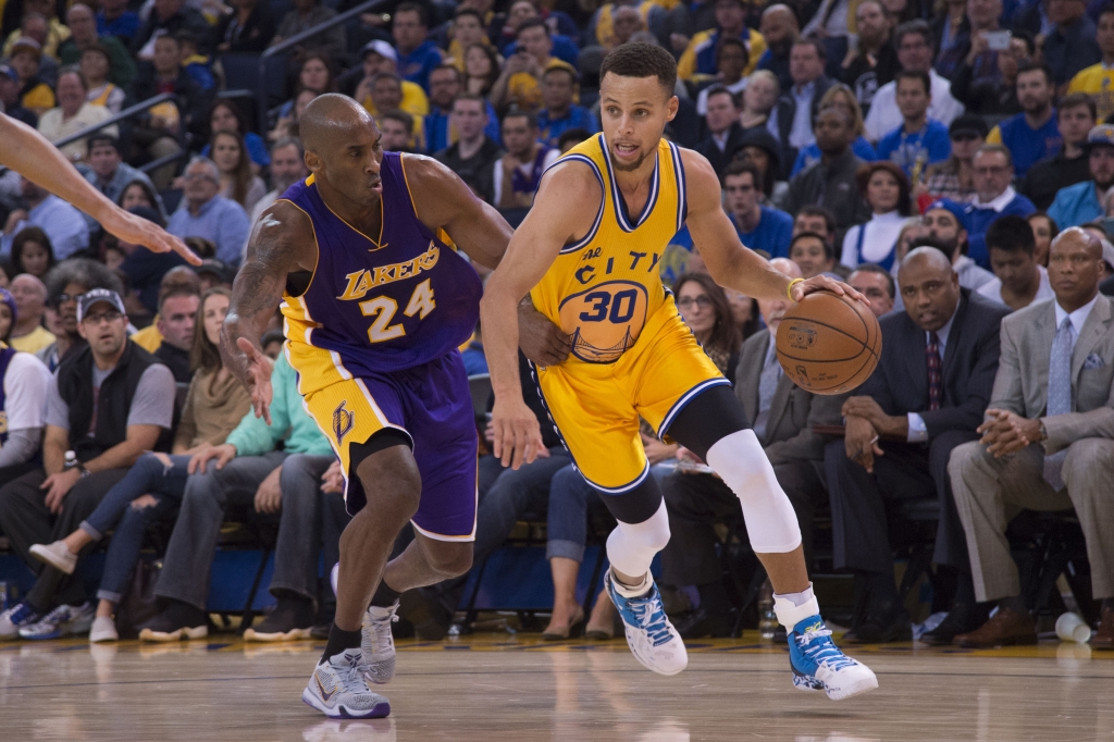 Oakland CA USA Golden State Warriors guard Stephen Curry dribbles the basketball against Los Angeles Lakers forward Kobe Bryant during the third quarter at Oracle Arena. The Warriors defeated the Lakers 111-77. Mandatory Cr