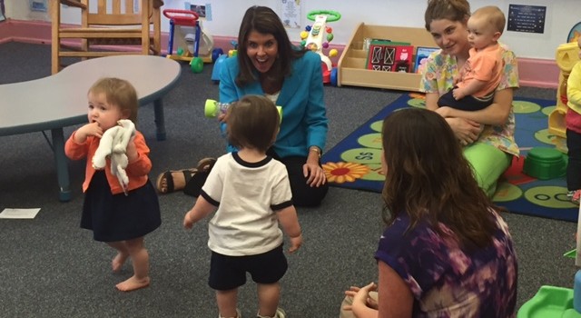 State DHHR Cabinet Secretary Karen Bowling plays with toddlers at the WV Public Employees Day Care Center in Charleston Monday during National Infant Immunization Week