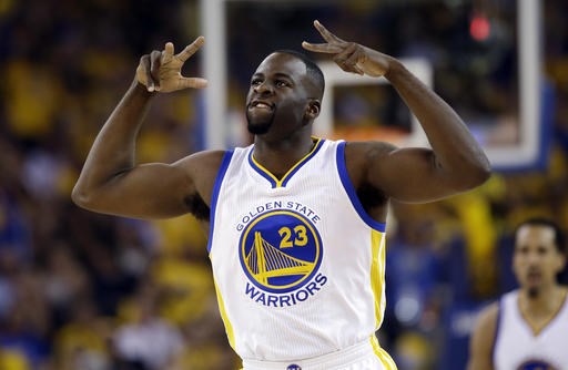 Golden State Warriors Draymond Green reacts after scoring against the Houston Rockets during the first half in Game 5 of a first-round NBA basketball playoff series Wednesday