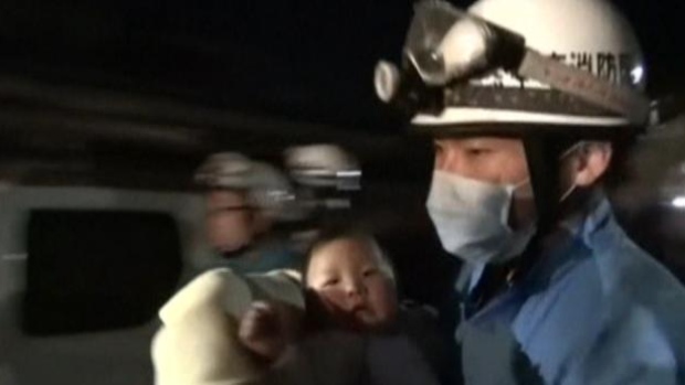 Miku Nishimura an eight-month-old baby is carried away after being rescued from her home collapsed by a magnitude-6.5 earthquake in Mashiki town