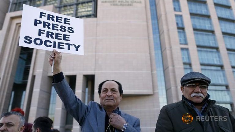 Supporters of Can Dundar editor-in-chief of Cumhuriyet wait in front of the Justice Palace in Istanbul Turkey