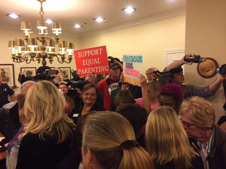 Supporters vied with opponents of a controversial alimony bill in front of Gov. Rick Scott’s office last week