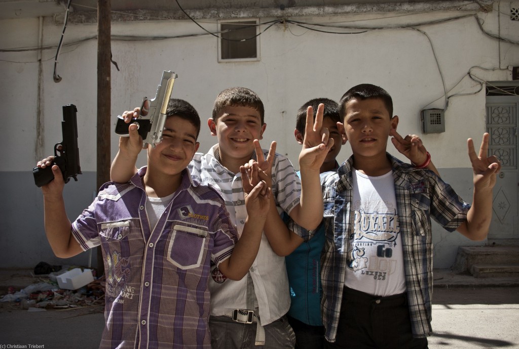 Syrian boys flaunting handguns