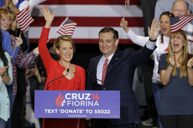 Ted Cruz joined by former Hewlett Packard CEO Carly Fiorina waves during a rally in Indianapolis Wednesday