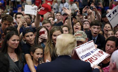 Republican presidential candidate Donald Trump greets supporters after speaking at a campaign event at Stephen Decatur High School Wednesday