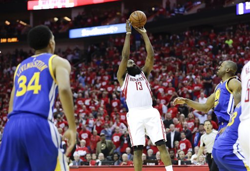 Houston Rockets guard James Harden scores the winning basket during the second half in Game 3 of a first-round NBA basketball playoff series against the Golden State Warriors Thursday