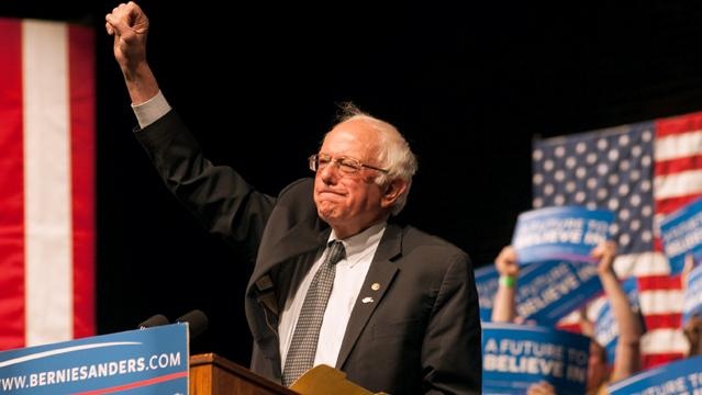 Bernie Sanders supporters held signs Tuesday during a rally in Laramie Wyo