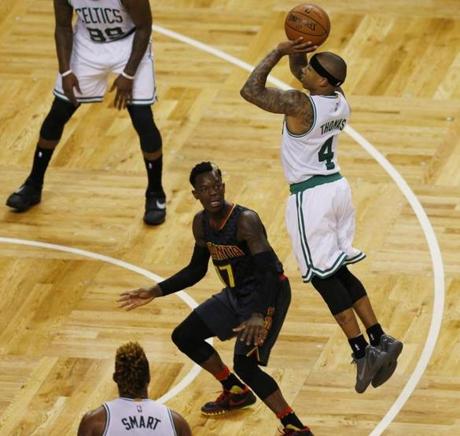 Boston MA- 4/22/2016- Boston Celtics Isaiah Thomas goes up for a shot in front of Atlanta Hawks Dennis Schroder during the third quarter at TD Garden in their third playoff game in Boston MA