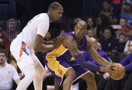 Kobe Bryant No. 24 of the Los Angeles Lakers tries to drive around Kevin Durant No.35 of the Oklahoma City Thunder during the first quarter of a NBA game at the Chesapeake Energy Arena in Oklahoma City Oklahoma. AFP