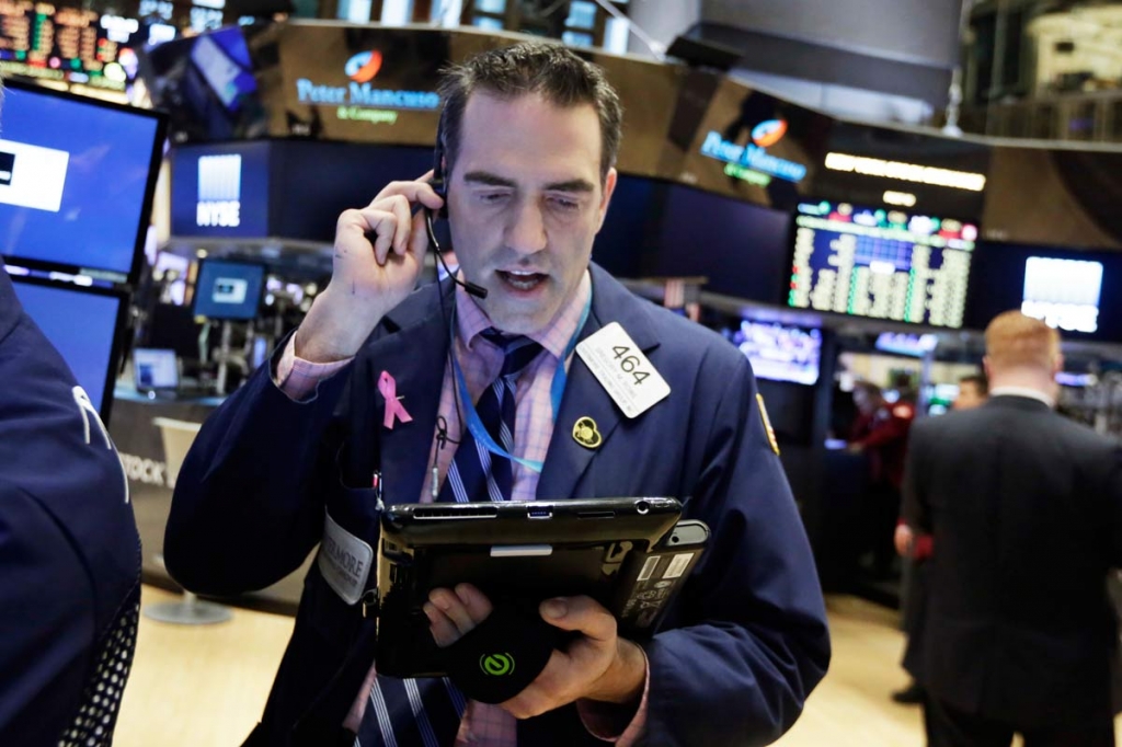 Trader Gregory Rowe works on the floor of the New York Stock Exchange Monday