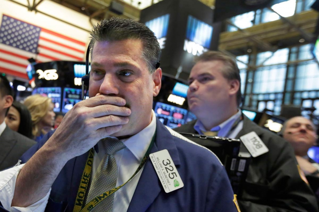 Trader William McInerney left works on the floor of the New York Stock Exchange Wednesday