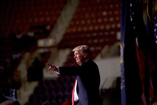 Republican presidential hopeful Donald Trump points to supporters following a rally at the Pennsylvania Farm Show Complex & Expo Center