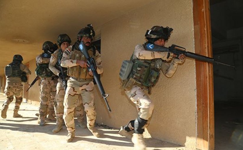 Iraqi soldiers from 2nd Battalion 71st Brigade enter a room after breaching the doorway to ensure that it is clear at Camp Taji Iraq Jan. 10 2016. Task Group Taji provides company-level urban operations training to teach Iraqis how to move and commun