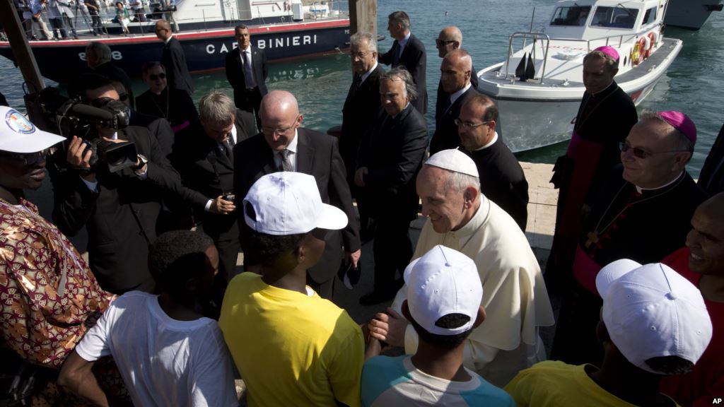 FILE- Pope Francis speaks to migrants during his visit to the island of Lampedusa southern Italy