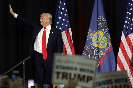 Republican presidential candidate Donald Trump waves as he arrives for a campaign rally at West Chester University on Monday in Pennsylvania