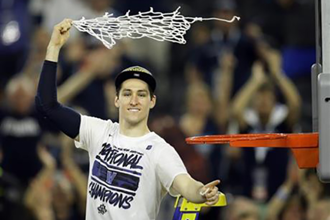 Villanova's Ryan Arcidiacono celebrates after cutting down the net after the NCAA Final Four tournament college basketball championship game Monday