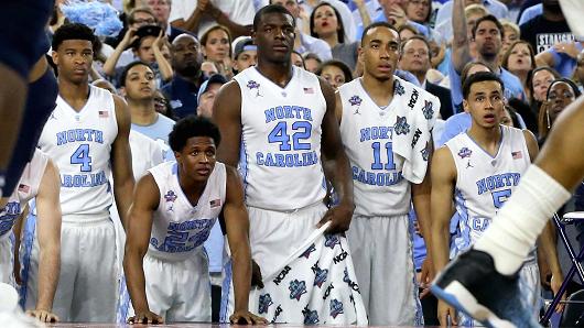 Isaiah Hicks #4 of the North Carolina Tar Heels Kenny Williams #24 Joel James #42 Brice Johnson #11 and Marcus Paige #5 look on from the bench in the first half against the Villanova Wildcats during the 2016 NCAA Men's Final Four National Champio