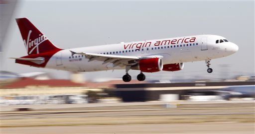 Virgin America's inaugural flight between Los Angeles and Dallas Fort Worth International Airport comes in for a landing in Grapevine Texas. Alaska Air Group Inc. is buying Virgin America in a deal worth more